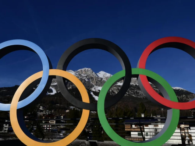 The Winter Olympics 2026 logo displayed in front of the Italian Alps.