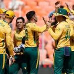 South Africa vs Afghanistan players celebrating in Ahmedabad.