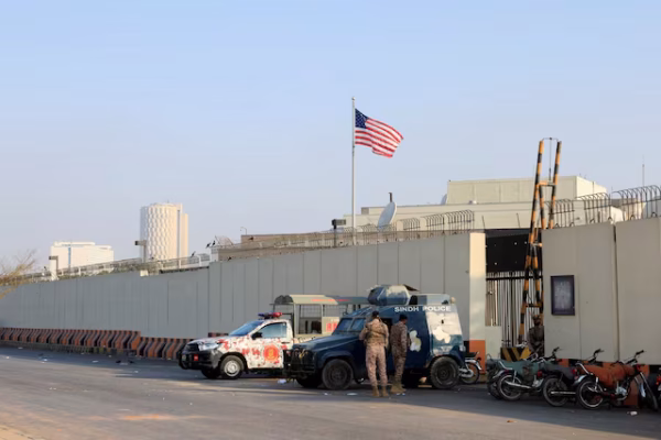 A photo showing security barriers and police presence outside the U.S. diplomatic mission in Karachi during the 2026 protests.